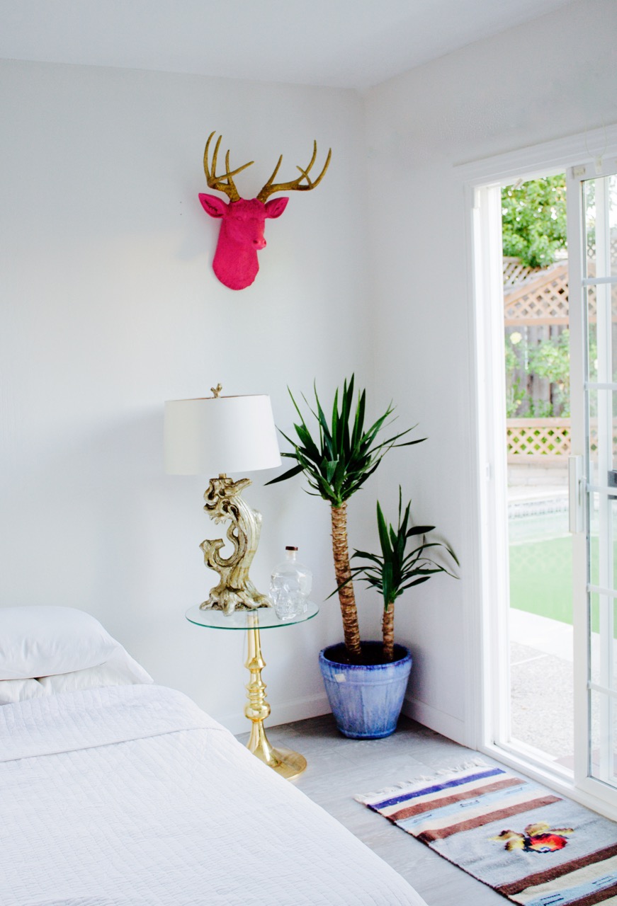 Hot pink and gold deer head from White Faux Taxidermy and yucca tree in bedroom