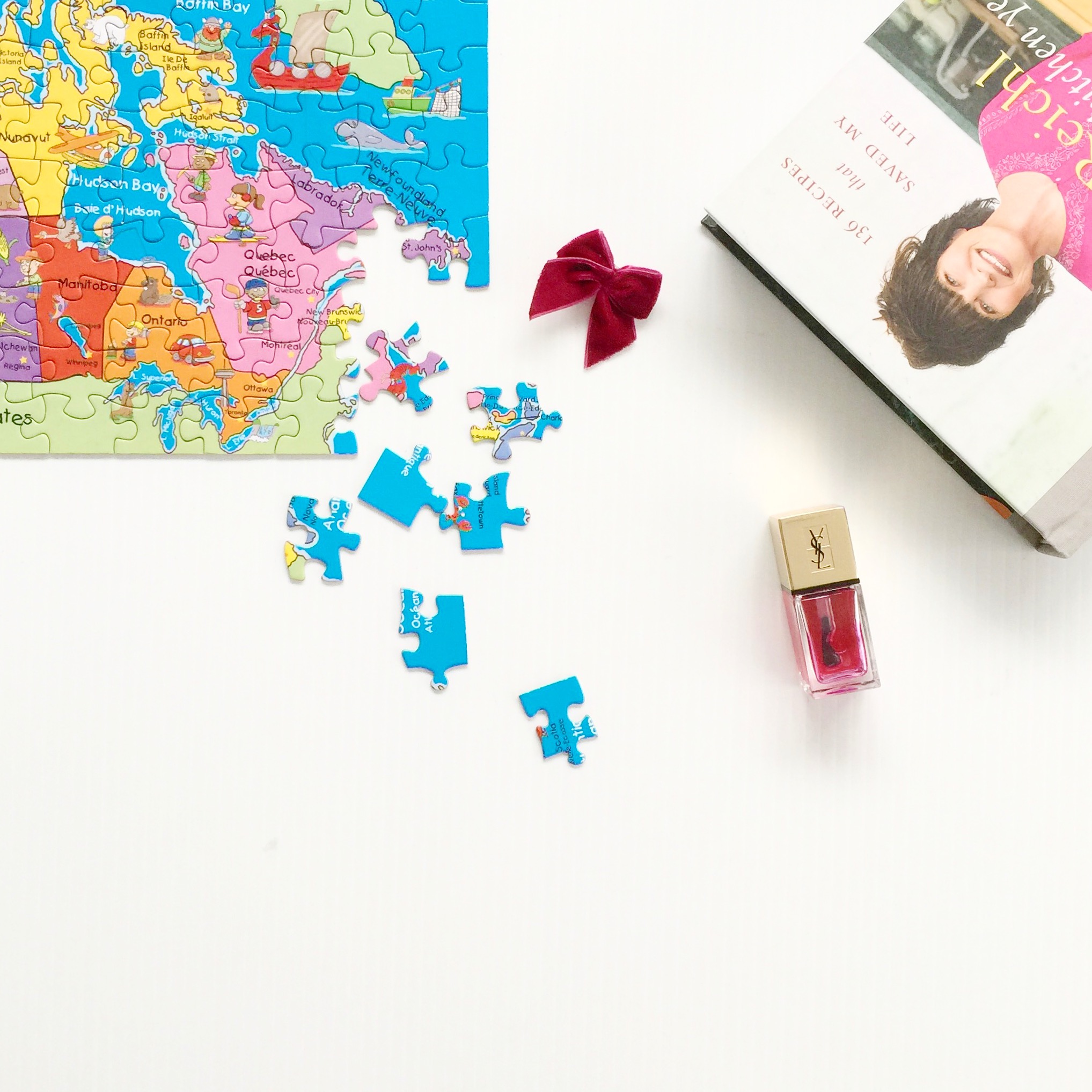a map puzzle and ruth reichl's new book on a white background