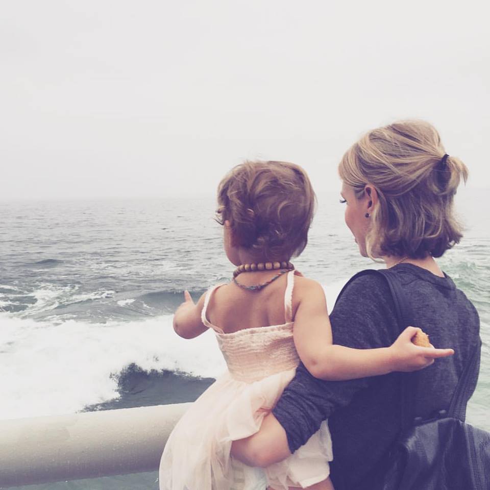 Mother and baby looking at ocean