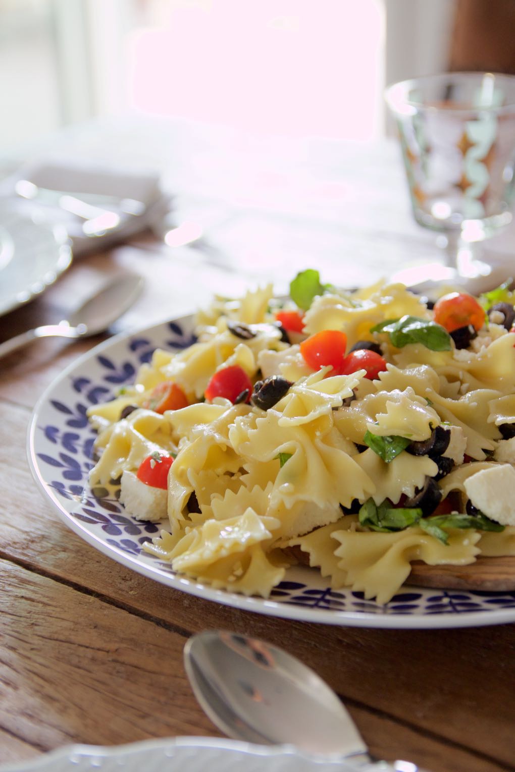 pasta with tomatoes, olives, cheese and basil