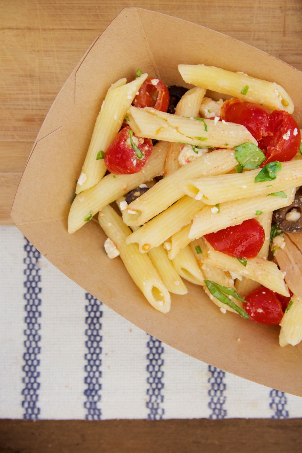 cold summer pasta with olives feta and tomatoes perfect for a picnic
