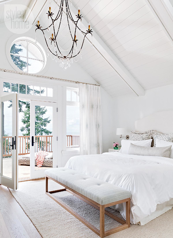 bright white coastal style bedroom with big windows