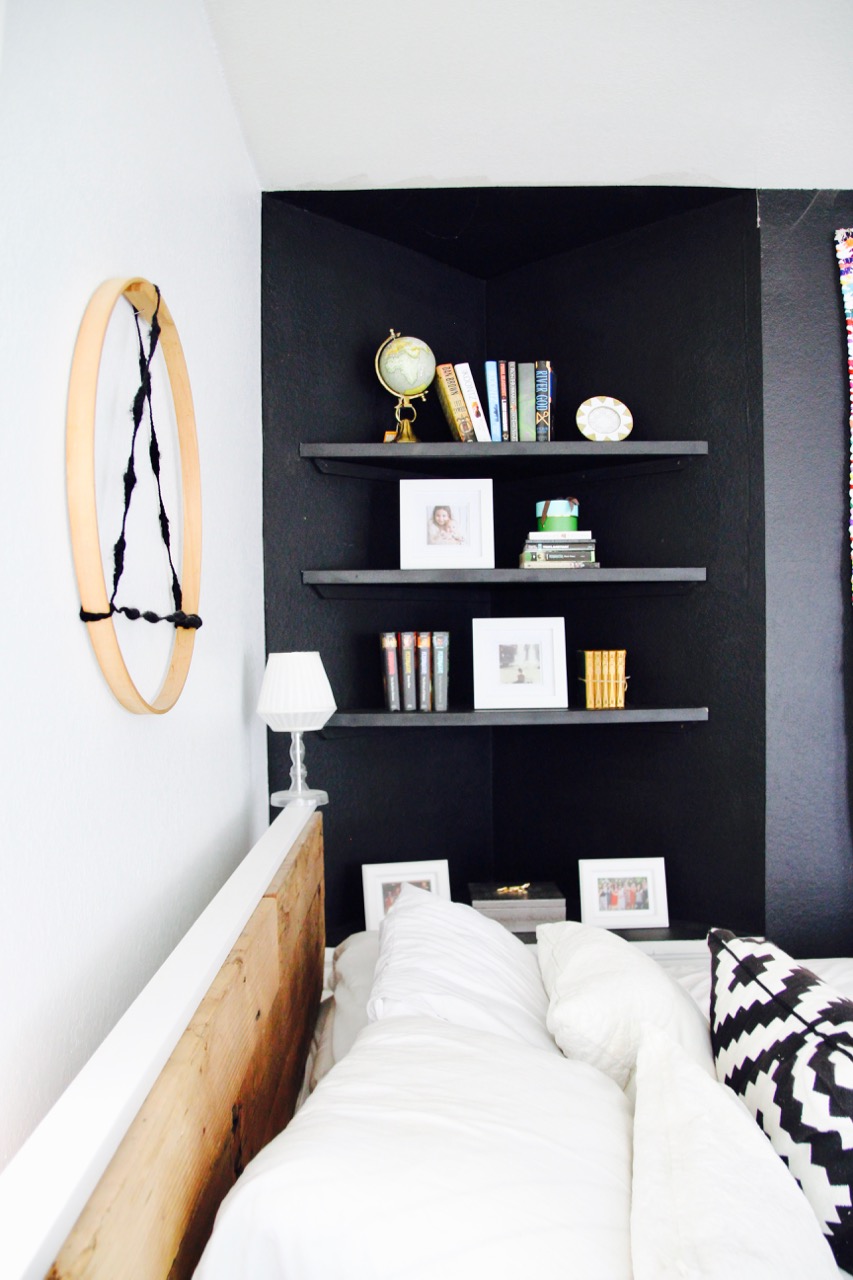 black wall in an all white bedroom