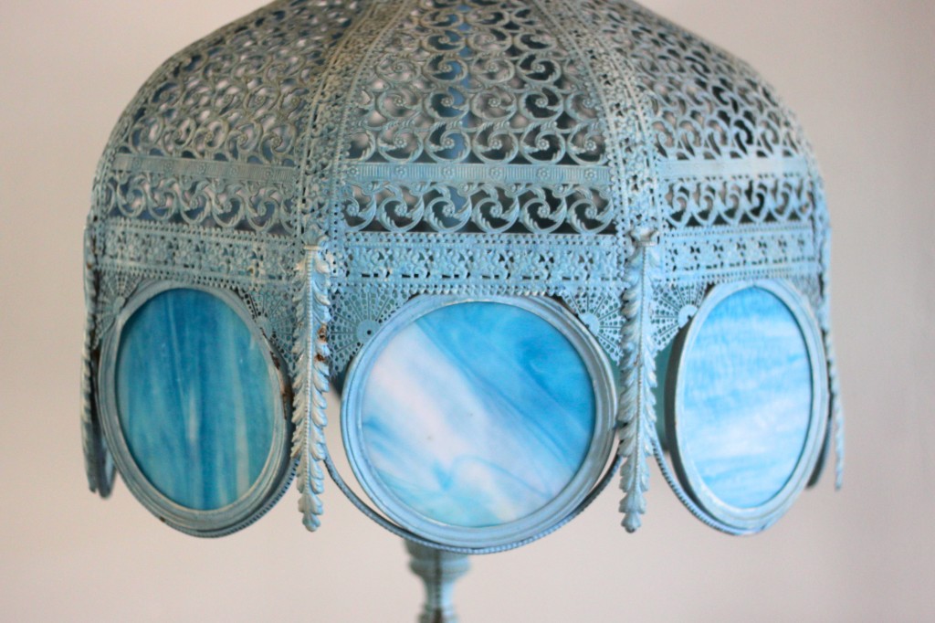 large wrought iron base lamp with translucent blue glass panels