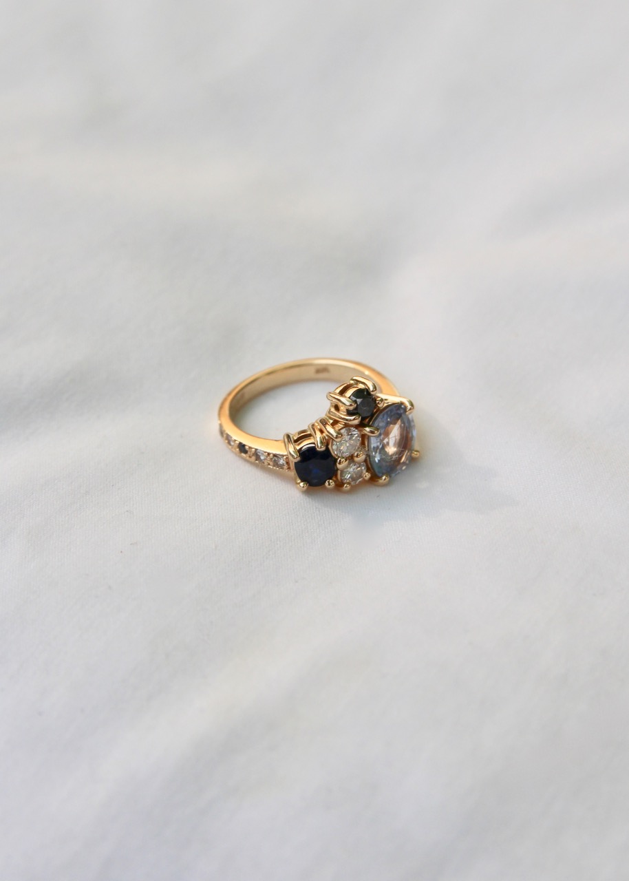 asymmetrical engagement ring made with sapphires and black diamonds