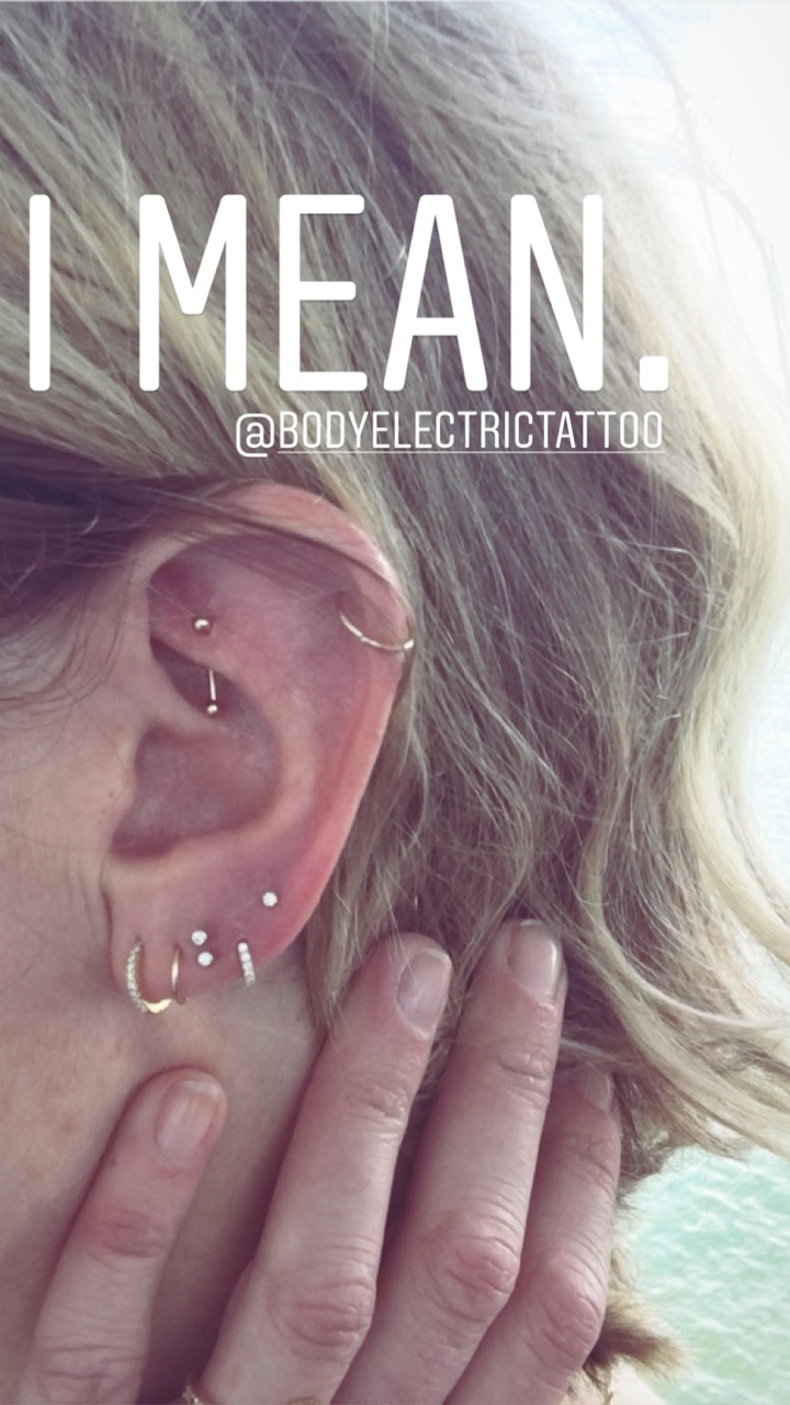 multiple small diamond single earrings in one ear
